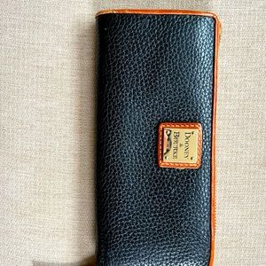 Dooney and Bourke black leather wallet with brown leather trim and red interior